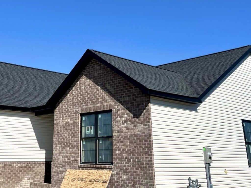New construction siding installation Mascoutah IL home with vinyl siding and brick front elevation