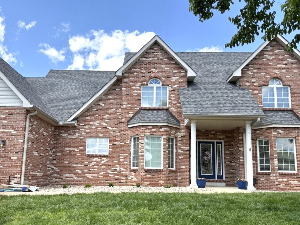 Brick home in Freeburg IL with light gray architectural shingle roof improving curb appeal