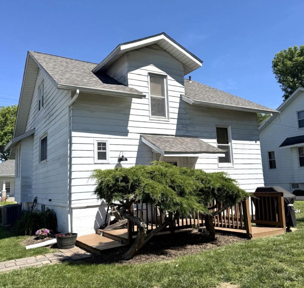 Older home in New Athens IL that may need roof replacement due to aging shingles and weather exposure
