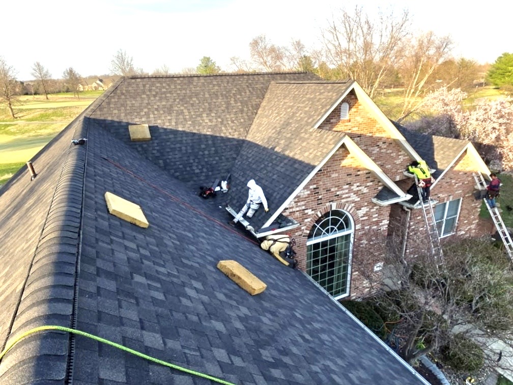 Roof replacement crew installing architectural shingles on a home in Caseyville IL