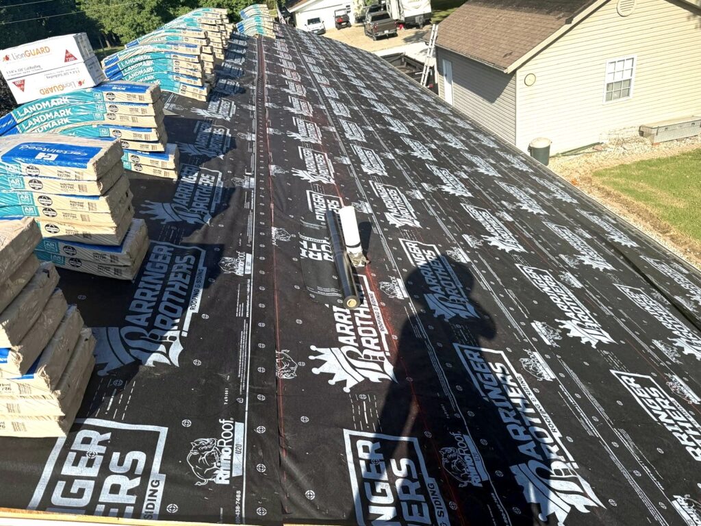 Roof replacement in progress with underlayment and CertainTeed asphalt shingles ready for installation by Barringer Brothers Roofing.