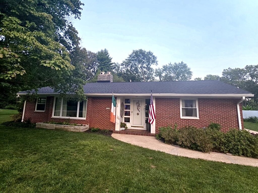 Completed asphalt roof replacement on a brick home in Belleville, IL by Barringer Brothers Roofing.
