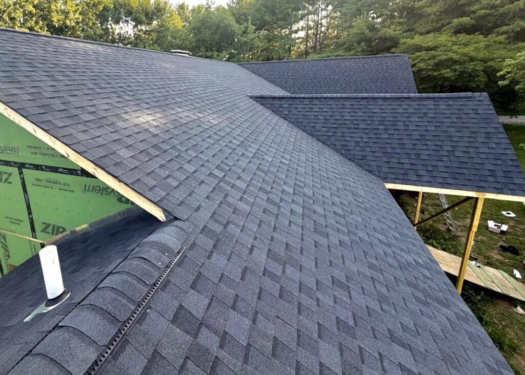 Complicated asphalt shingle roof with multiple rooflines on a new construction home in Columbia, IL.