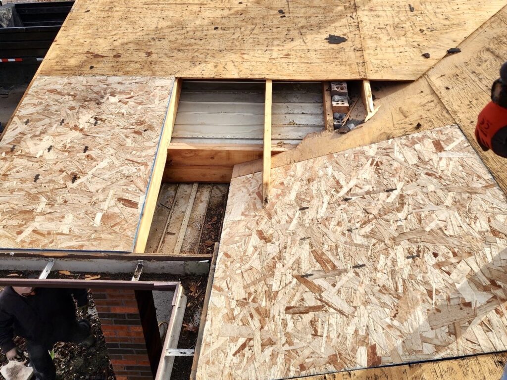 Rotted roof decking being removed and replaced during a roofing project in Millstadt, IL by Barringer Brothers Roofing.