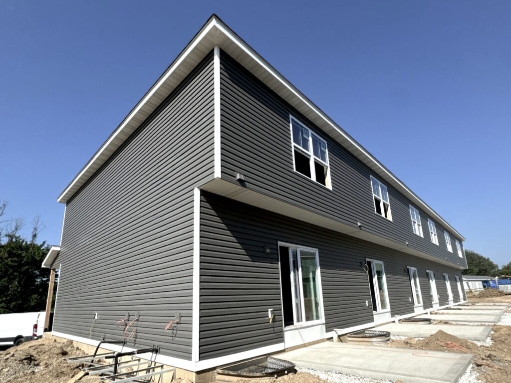 Siding installation on a two-story home in O'Fallon, IL by Barringer Brothers Roofing.