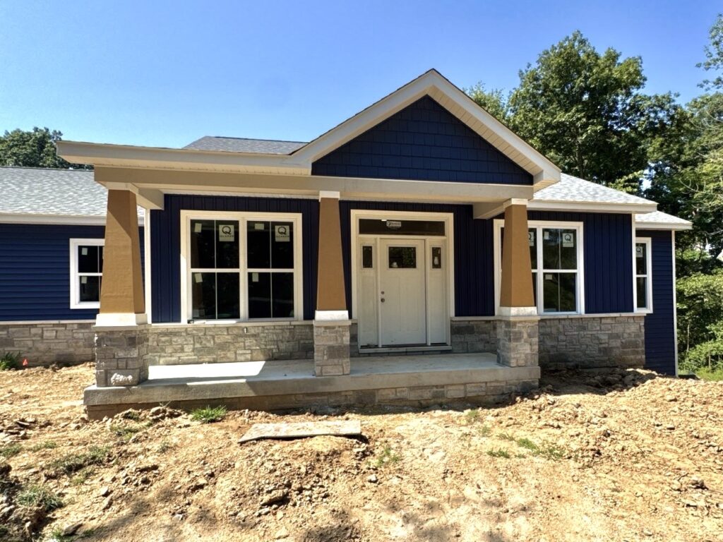 Dark blue siding installation on a new construction home in Edwardsville, IL by Barringer Brothers Roofing.