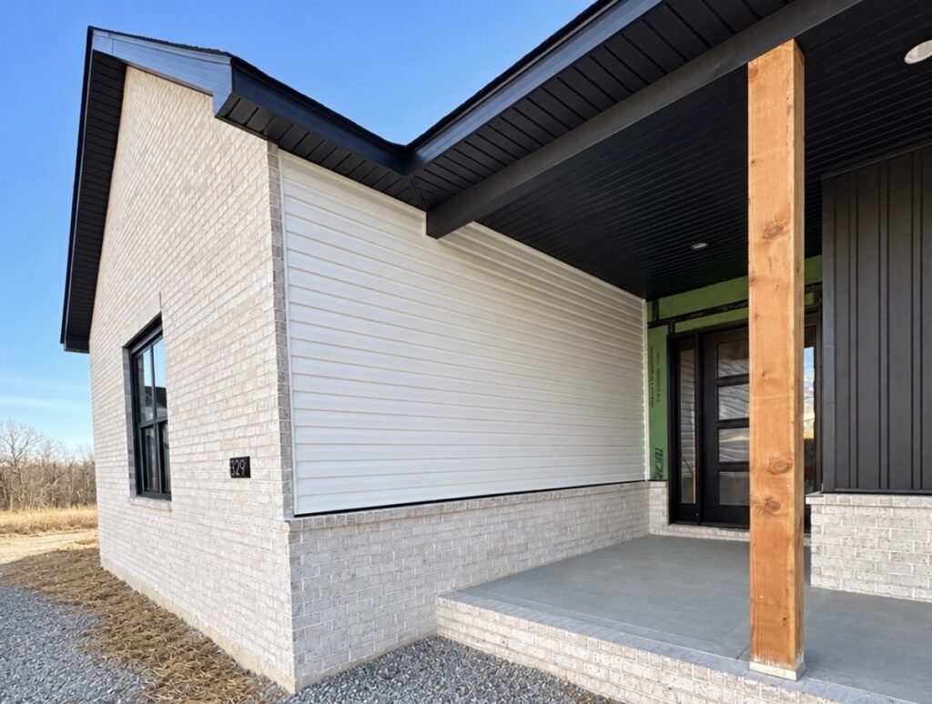 New construction siding installation on a two-story home in O'Fallon, IL by Barringer Brothers Roofing.